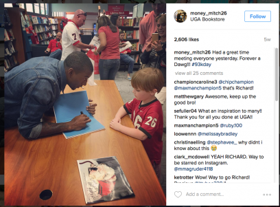 Malcolm Mitchell signing a copy of his book at the UGA Bookstore. Image via Instagram